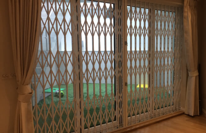 RSG1000 retractable security grille, closed and securing a patio door of a house in Hammersmith.