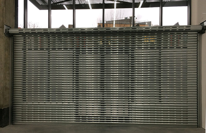 RSG5000 punched steel shutter on a high street shop front in London city.