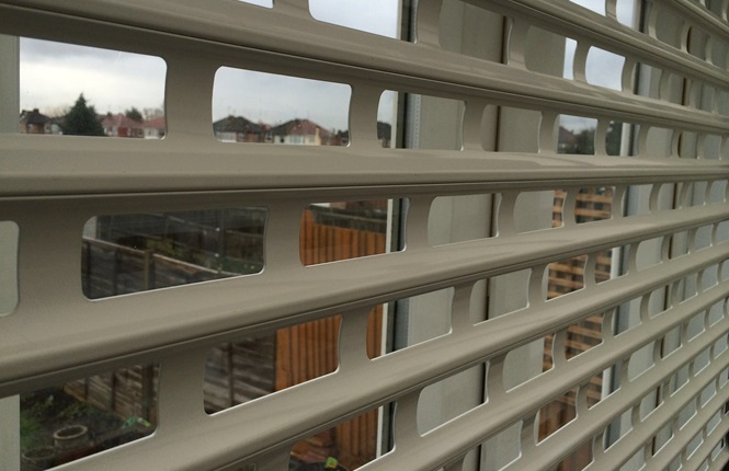 RSG5100 domestic roller shutter with 84mm punched laths in a brick bond style fitted in Middlesex.