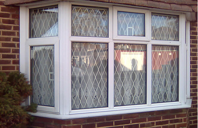 RSG800 fixed mesh grilles protecting a front bay window of a home in West London.
